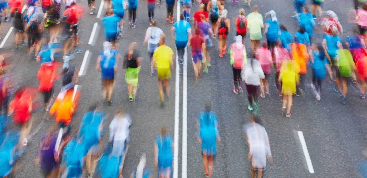 Runners on the street. Athletes in motion. Urban competition.