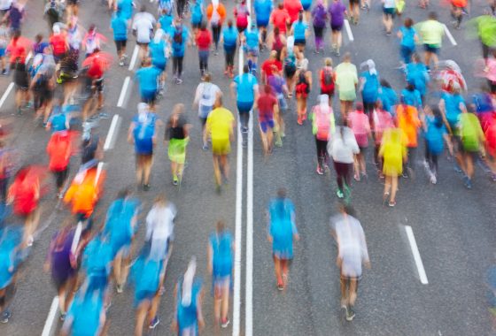 Runners on the street. Athletes in motion. Urban competition.
