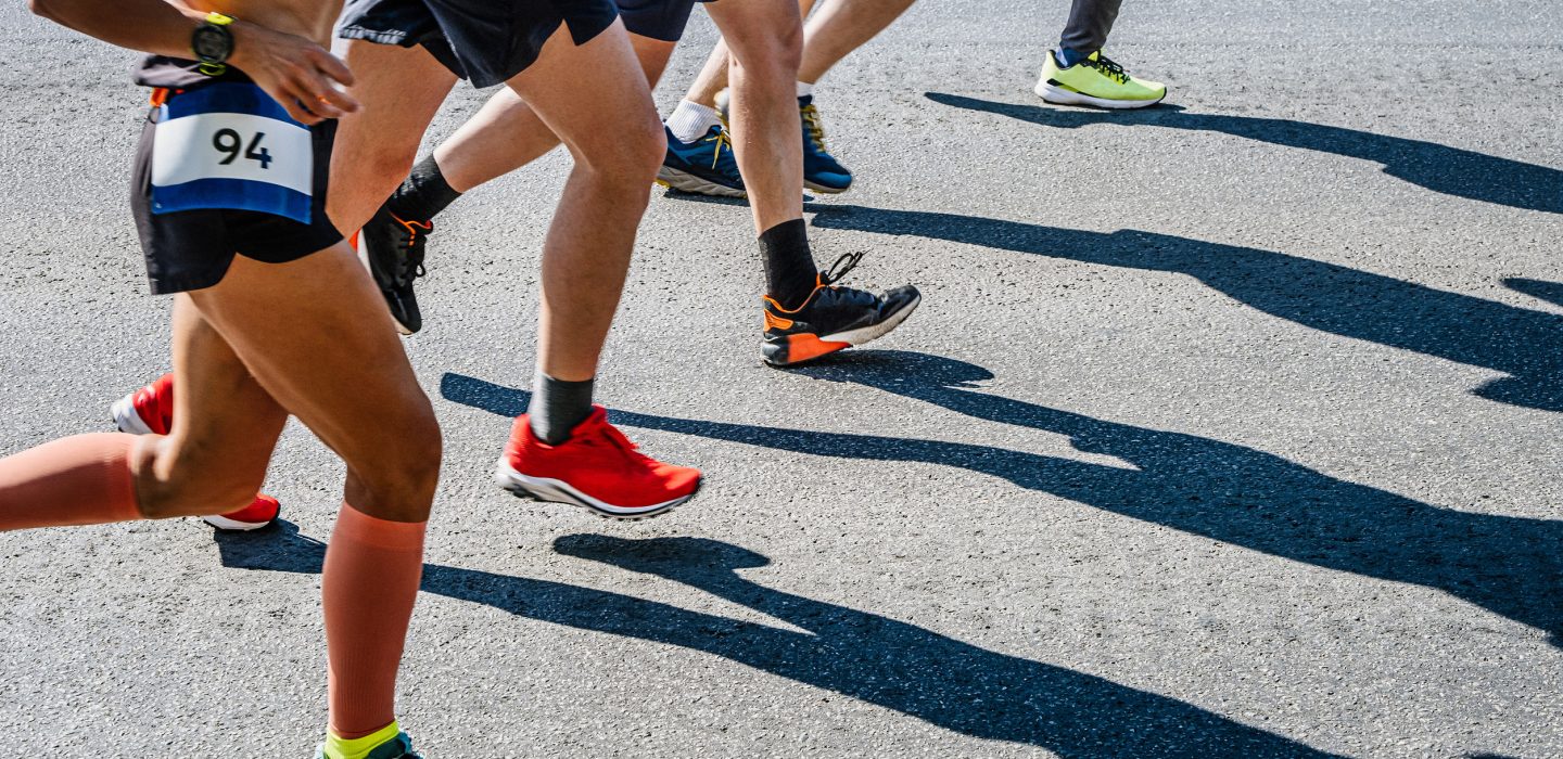 legs group runners run marathon race on road