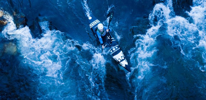 A girl doing kayaking down the river