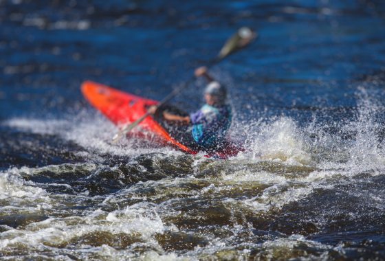 Kayak slalom canoe race in white water rapid river, process of kayaking competition with colorful canoe kayak boat paddling, process of canoeing with big water splash